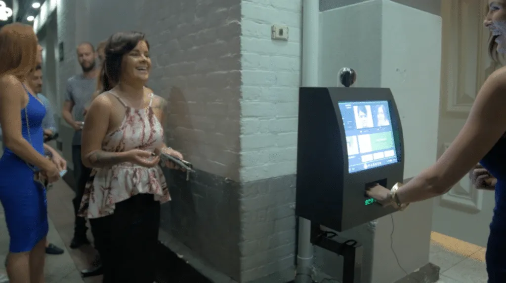 A Scantek ID scanning kiosk being used at a venue entrance.