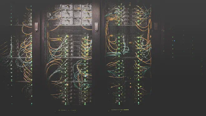 A photo of a server room with cables and lights.